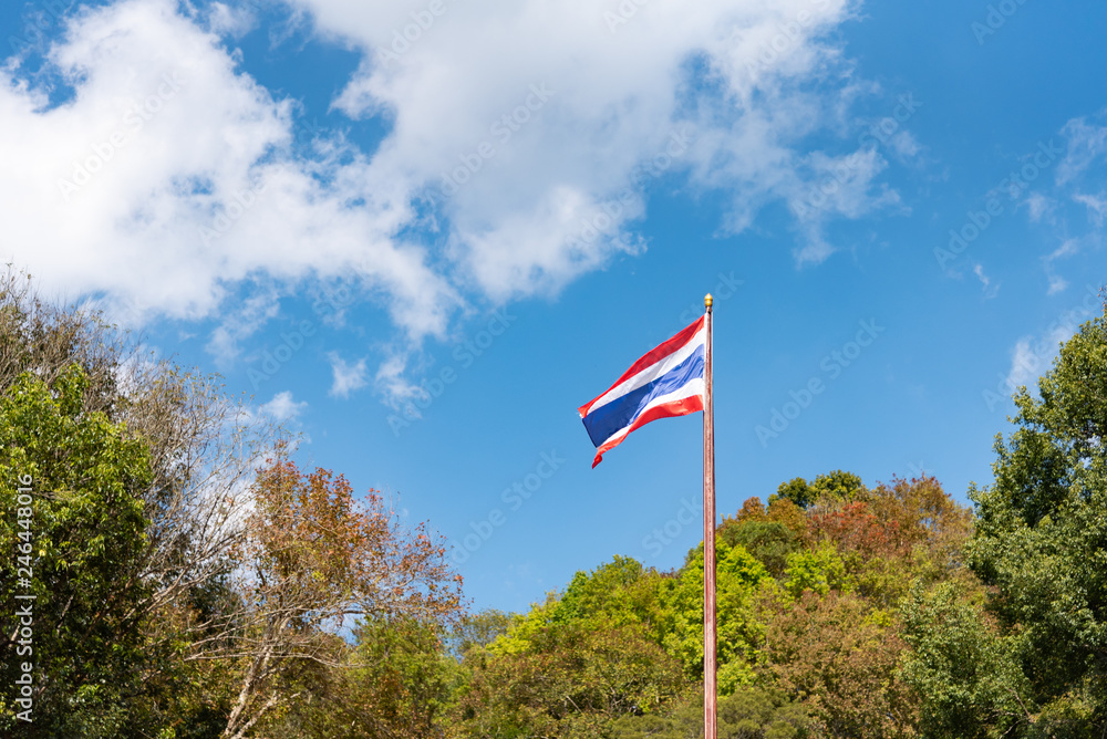Thai flag blowing in the wind Trees around the sky and clouds