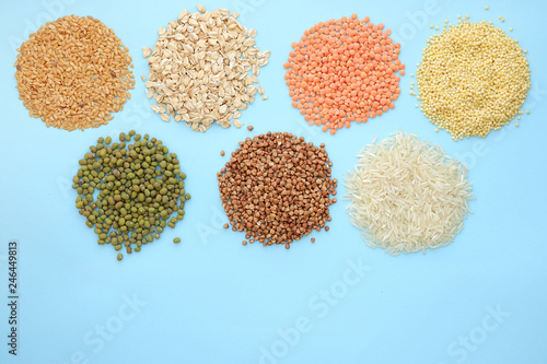 Multi-colored cereals on a blue background, copy space