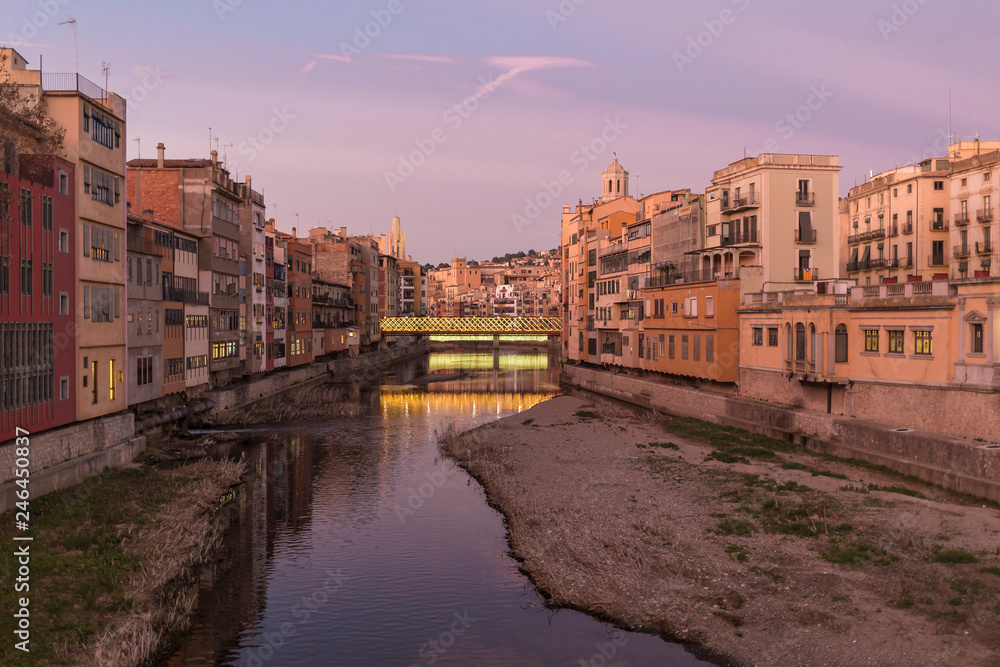 Girona's skyline famous landmark river view at the sunset. Onyar river and Cathedral skyline cityscape in famous city in Catalonia