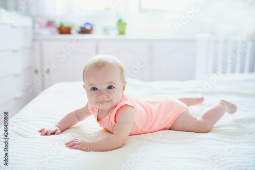 Canvas Print Cute baby girl lying on her tummy