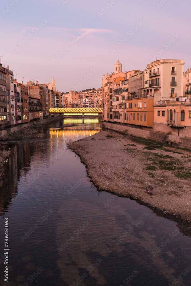 Girona's skyline famous landmark river view at the sunset. Onyar river and Cathedral skyline cityscape in famous city in Catalonia