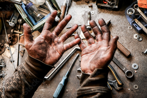 Canvas Print A picture of dirty hands of a guy from the garage