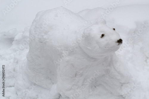 The figure of the white bear cobbled together out of the snow children. Bear-snowman © Yulia
