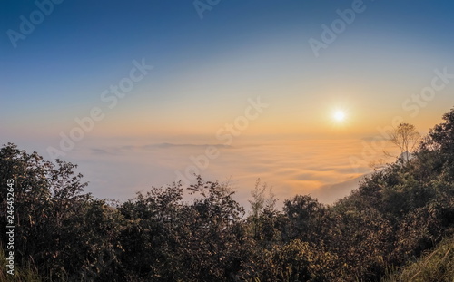 sunrise at Doi Samur Dao  mountain view misty morning of the hill around with sea of mist with colorful of yellow sun light in the sky background  Sri Nan National Park  Nan Province  Thailand.