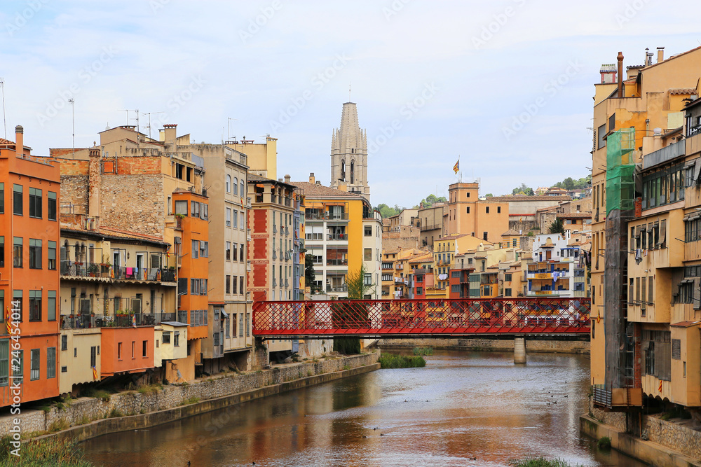 Colorful houses and Eiffel bridge on river Onyar in Girona