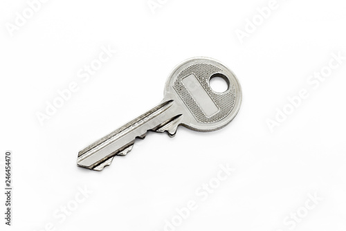 Silver classical key isolated on white background © Dinadesign