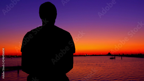 Thoughtful Man looks at sea sunset