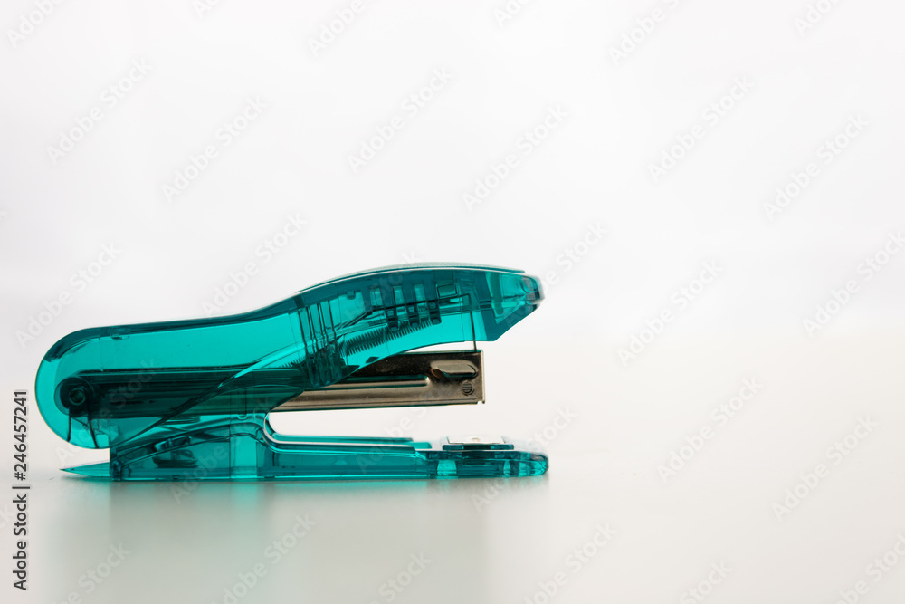 aqua colored Transparent Stapler. isolated with a white background aqua colored Transparent Stapler. isolated with a white background