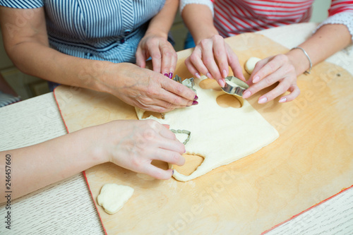 women in the kitchen preparing cookies from the dough