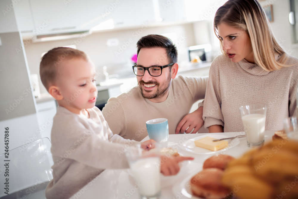 Young family having breakfast at home