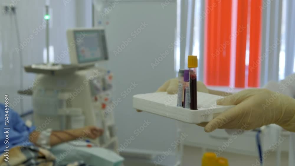 Hemodialysis center. Connecting a person to the apparatus of an artificial kidney. Test tubes with venous blood. Hemodialysis center. Connecting a person to the apparatus of an artificial kidney. Test tubes with venous blood.