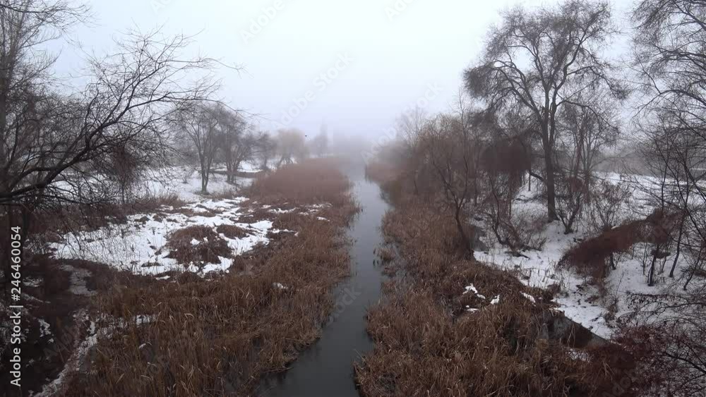 Mist over the current river in the park, snow, thaw, springtime. Top view. Mist over the current river in the park, snow, thaw, springtime. Top view.
