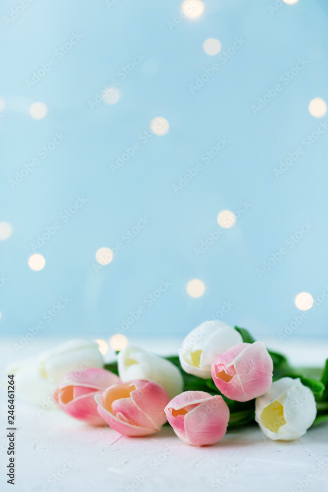 bouquet of tulips with bokeh lights on a blue background.