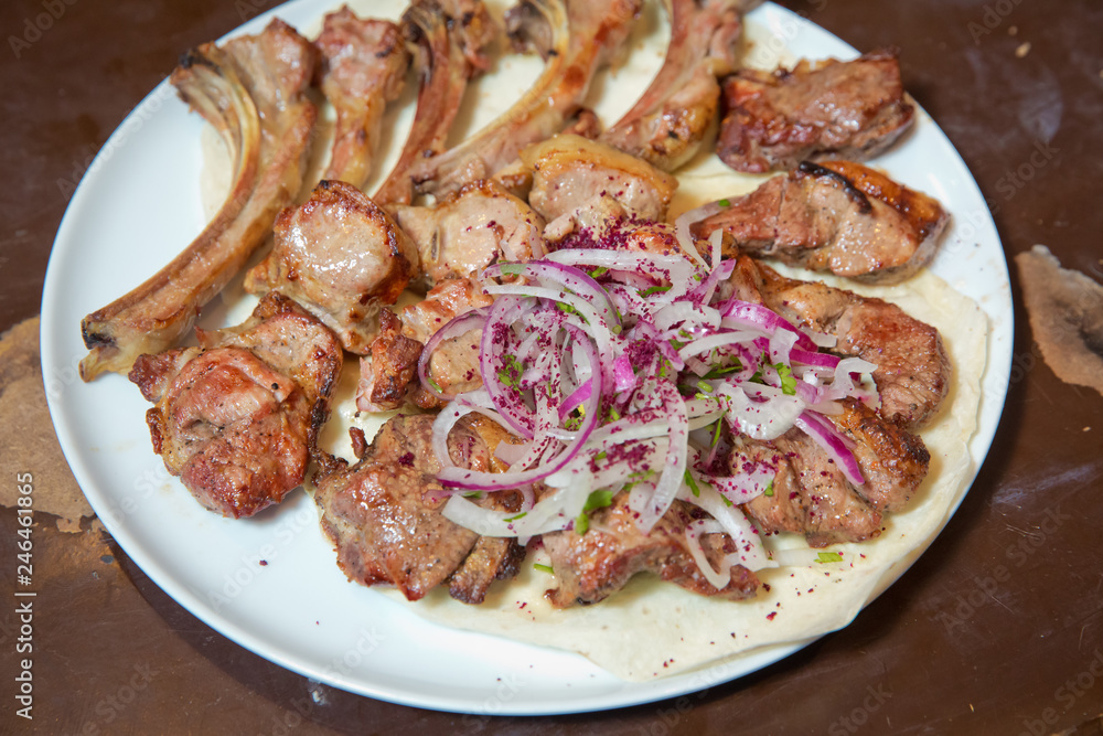 Mutton kebab on plate, close up view . Kebab with onion . Sheep meat Kebab. Mutton kebab on plate, close up view . Kebab with onion . Sheep meat Kebab.