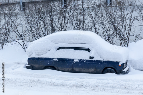 Car in a snowdrift after heavy snow