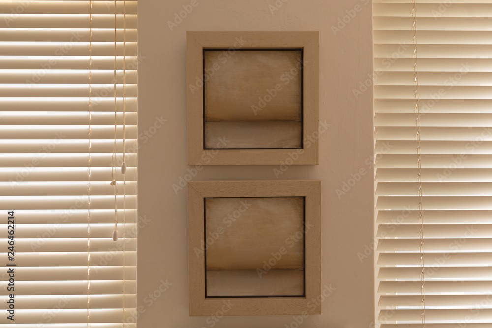Wall frame near window blinds Wall frame near window blinds