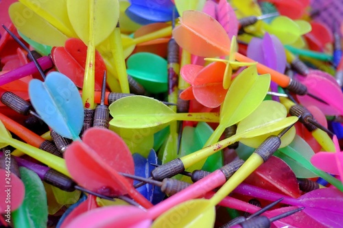 A pile of multicolored old darts in a box  photo