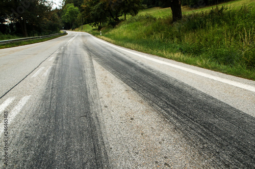 The rubber tracks from the racing cars left on the tarmac at the start of the hill climb stage.  © shootingtheworld