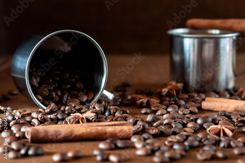 Roasted coffee beans scattered on the wooden table, side view