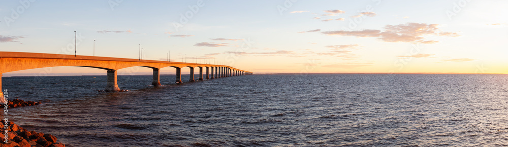 Panoramic view of Confederation Bridge to Prince Edward Island during a vibrant sunny sunrise. Taken in Cape Jourimain National Wildlife Area, New Brunswick, Canada.