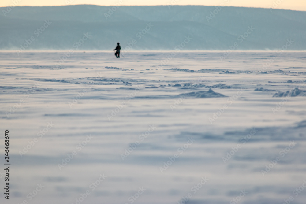 Man crossing winter landscape
