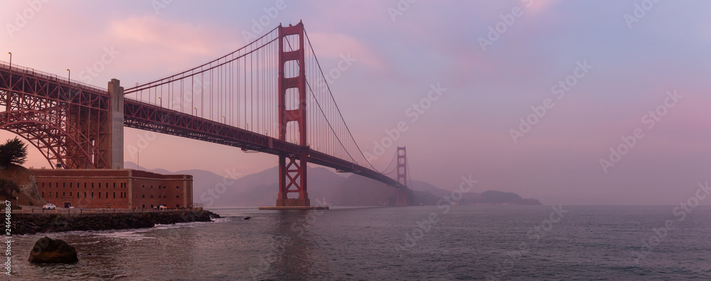 Beautiful view of Golden Gate Bridge during a cloudy sunset. Taken in San Francisco, California, United States. Beautiful view of Golden Gate Bridge during a cloudy sunset. Taken in San Francisco, California, United States.