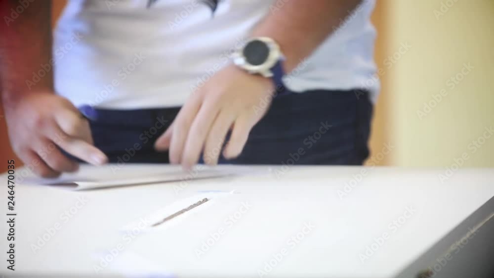Video of a person casting a ballot at a polling station, during elections. Video of a person casting a ballot at a polling station, during elections.