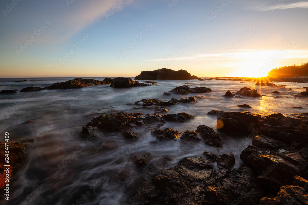 Beautiful rocky seascape on the Pacific Ocean Coast during a vibrant summer sunset. Taken in Hecht Beach, Northern Vancouver Island, BC, Canada.