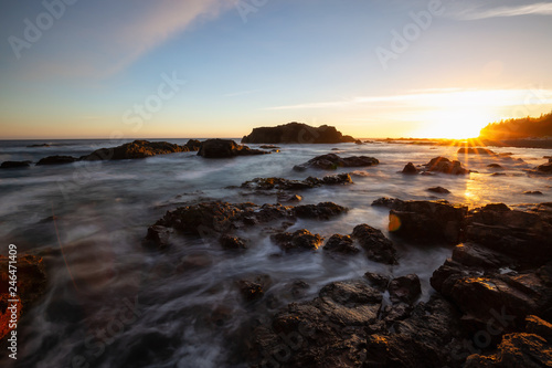 Beautiful rocky seascape on the Pacific Ocean Coast during a vibrant summer sunset. Taken in Hecht Beach, Northern Vancouver Island, BC, Canada.