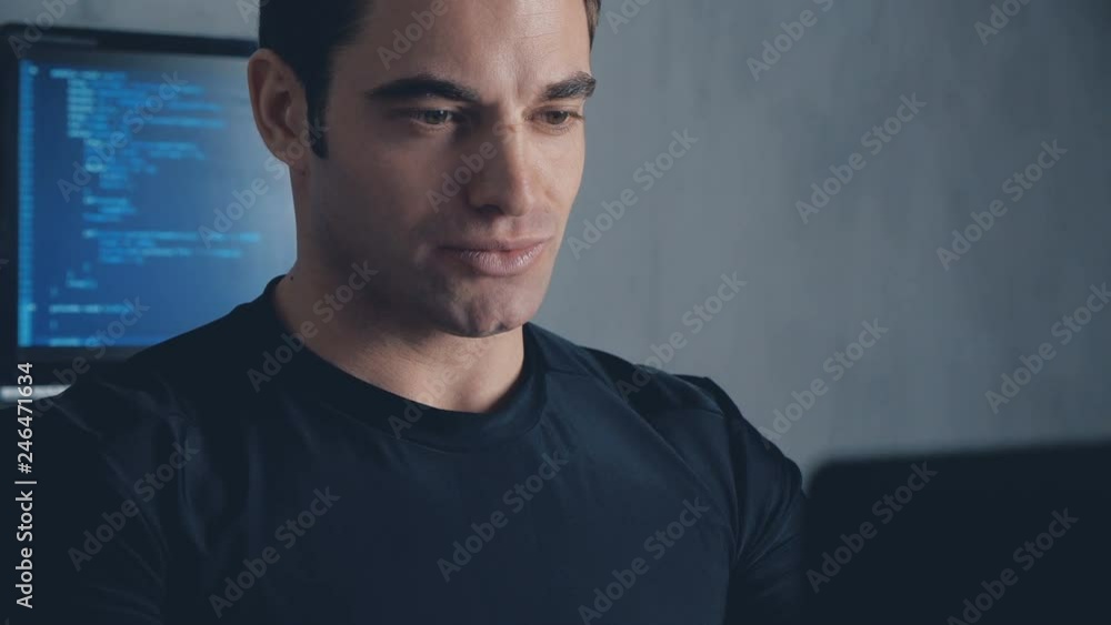 Portrait of Programmer Developer writes the source code of the software. Male worker concentrating on codes at the office. Steadicam shot Portrait of Programmer Developer writes the source code of the software. Male worker concentrating on codes at the office. Steadicam shot
