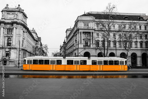 A picture of the typical yellow tram in Budapest, Hungary. The tram is isolated in the black and white background.