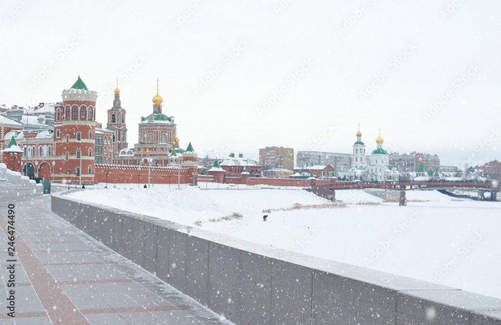 winter urban landscape with snow from buildings and Orthodox Church