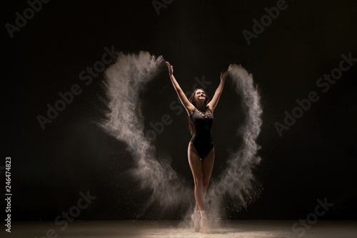 Emotional dancer in flying white powder