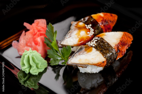 Japanese national popular cuisine. Sushi, rice and fish. Tasty, beautifully served food in a restaurant, cafe, with elements of the original design. photo