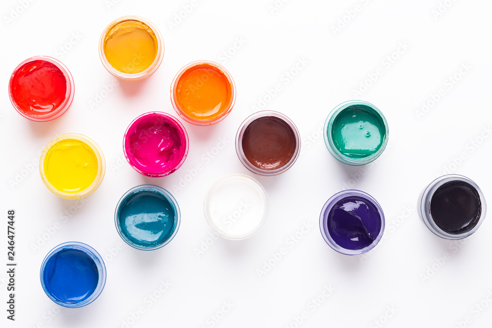Multicolored gouache on a white background Isolated Paints in containers Top view Copy space Multicolored gouache on a white background Isolated Paints in containers Top view Copy space