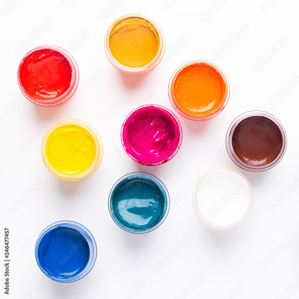 Multicolored gouache on a white background Isolated Paints in containers Top view Copy space Multicolored gouache on a white background Isolated Paints in containers Top view Copy space