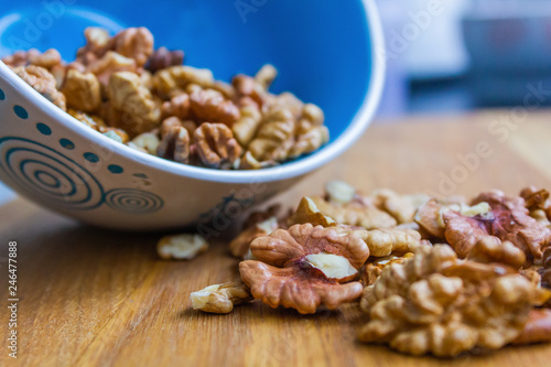 Close up of healthy brown walnuts scattered on the wooden table