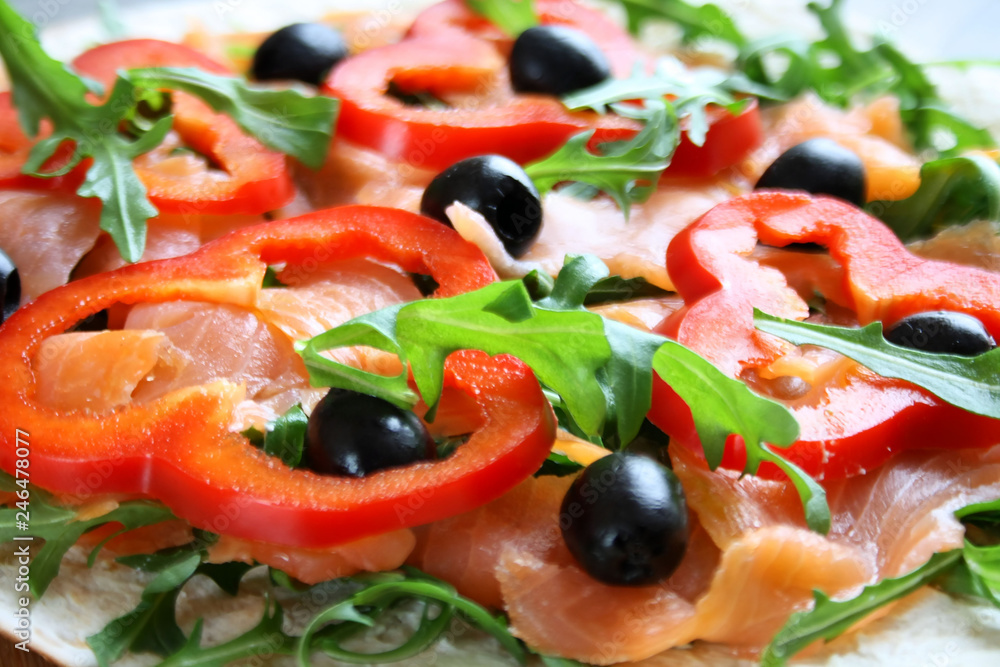 Smoked salmon, red pepper, arugula and black olives on a tortilla Smoked salmon, red pepper, arugula and black olives on a tortilla