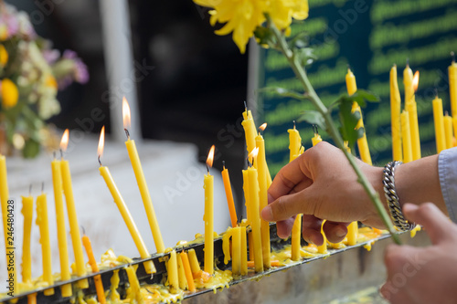 Candles being lit in front of temple. photo