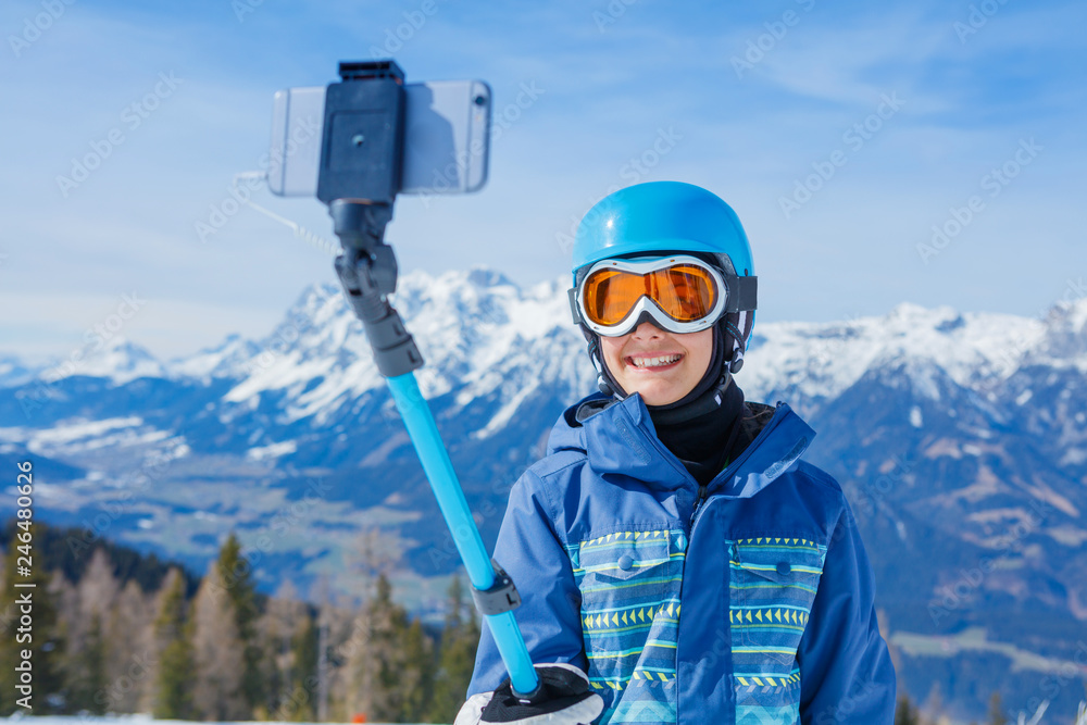 Portrait of Girl snowboarder making selfie in the winter ski resort.