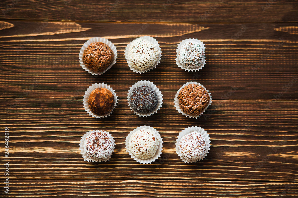the vegan of handmade candy on a wooden background. Fitness sweets. candies without sugar. the vegan of handmade candy on a wooden background. Fitness sweets. candies without sugar.