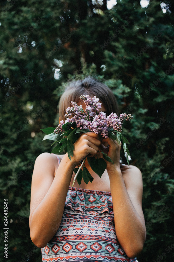 Young girl covering her face with a bouquet of fresh lilacs Stock Photo ...