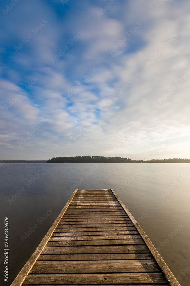 A bridge on the lake during a beautiful winter sunset