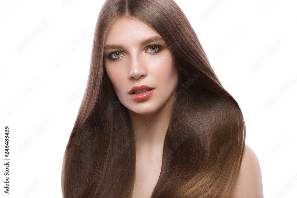 Beautiful brown-haired girl with a perfectly smooth hair, and classic make-up. Beauty face. Beautiful brown-haired girl with a perfectly smooth hair, and classic make-up. Beauty face.
