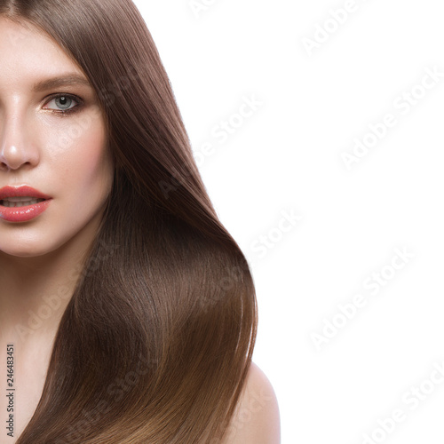 Beautiful brown-haired girl with a perfectly smooth hair, and classic make-up. Beauty face.