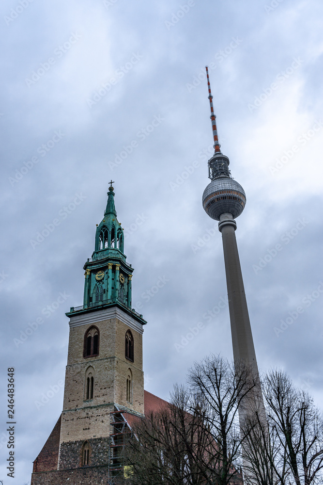 View of the tower of the Marienkirche (St. Marys) Church, and TV Tower in Berlin, Germany