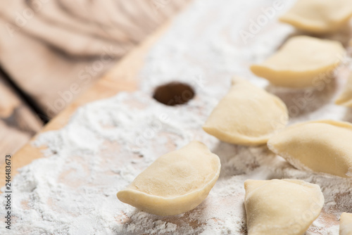 Raw dumplings ready to boil, close up, with copy space. Also known as Vareniks. Ukrainian traditional cuisine