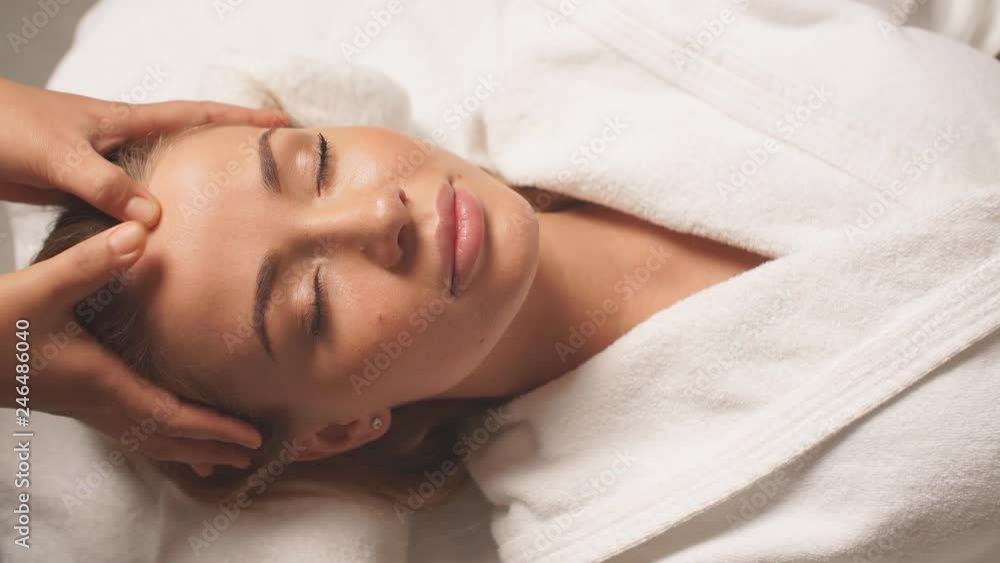 Gorgeous woman enjoys spa treatment in clinic. Girl takes care of her face Gorgeous woman enjoys spa treatment in clinic. Girl takes care of her face