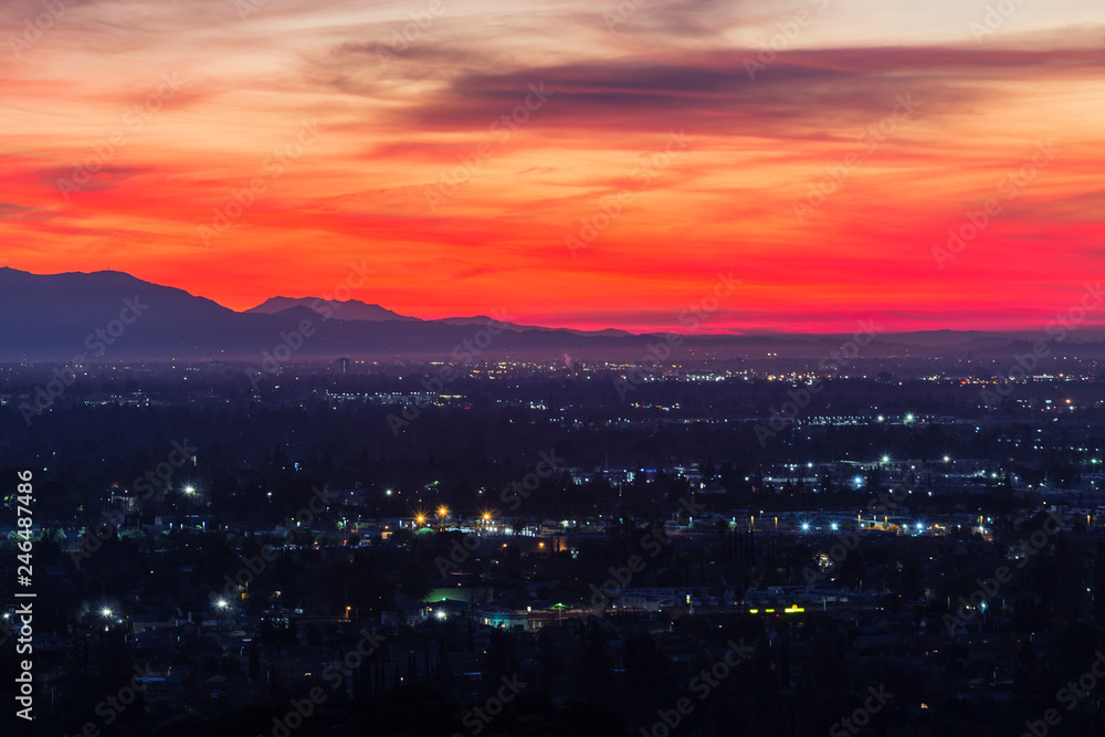 Colorful predawn view of San Fernando Valley neighborhoods and the San Gabriel Mountains in the city of Los Angeles, California.  