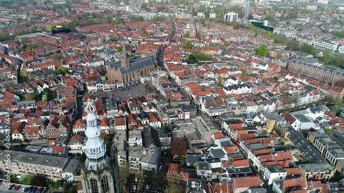 Aerial view of downtown Amersfoort city located in the province of Utrecht Netherlands showing Hof Square and Sint Joriskerk then moving backwards past onze lieve vrouwetoren bell tower 4k quality photo